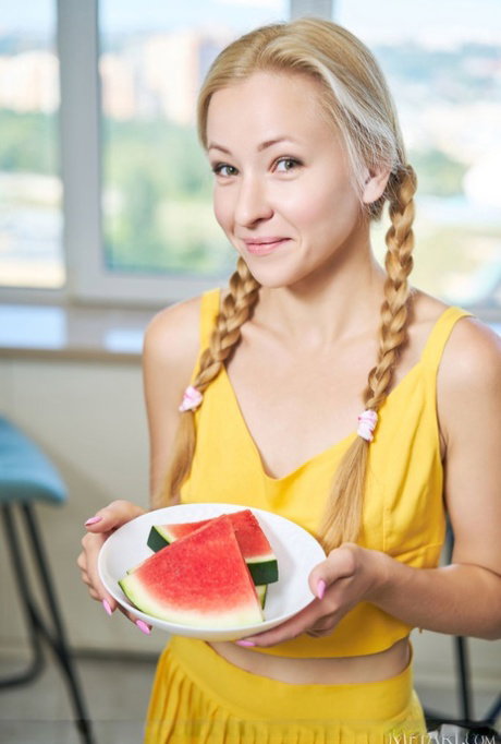 Blonde teen Sati Sol gets naked while eating slices of watermelon