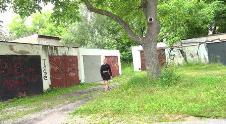 Blonde girl Nykla hitches up her dress before taking a piss by a garage