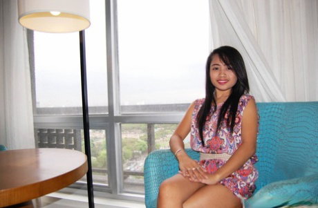 Young hottie shows off the pink of her pussy in a Manila hotel room