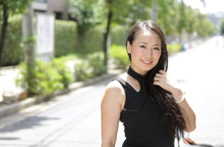 Japanese beauty Aya Shiina models on a city street in a black dress