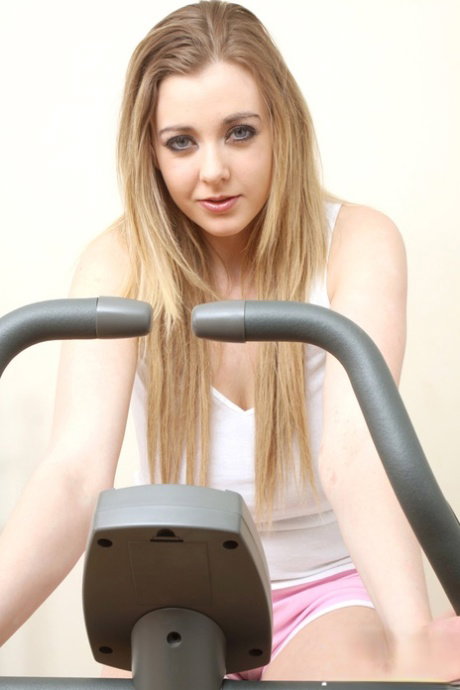 Sports girl Sapphire Blue undressing to exercise with bouncy big tits bared