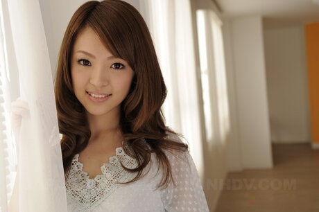 Japanese redhead Sayaka Fukuyama gets completely naked on a red sofa