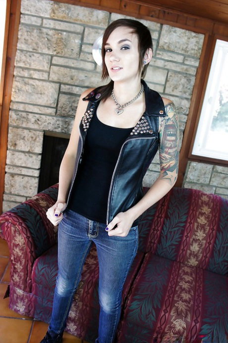 Slender tattooed babe in jeans gets naked and masturbates nicely