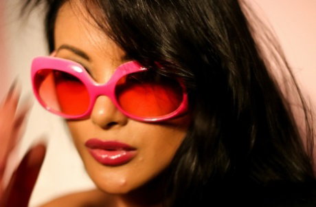 Black haired pornstar Keani Lei reveals her small titties and toys herself