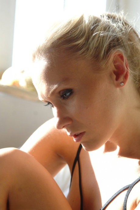 Blonde glamour model Michaela sets her from tits free of a lingerie on a couch