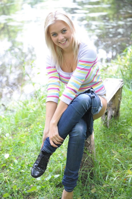 Blonde teen Berry A flaunts her nice juggs and trimmed pussy outdoors
