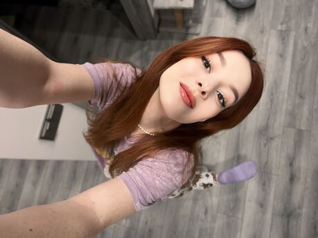 Nice redhead Sofi Foxxxy uncovers her small tits during a solo show