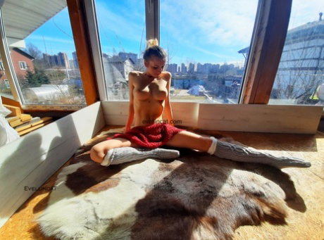 Beautiful leggy amateur babe Evellin Cat poses in her wool socks by the window