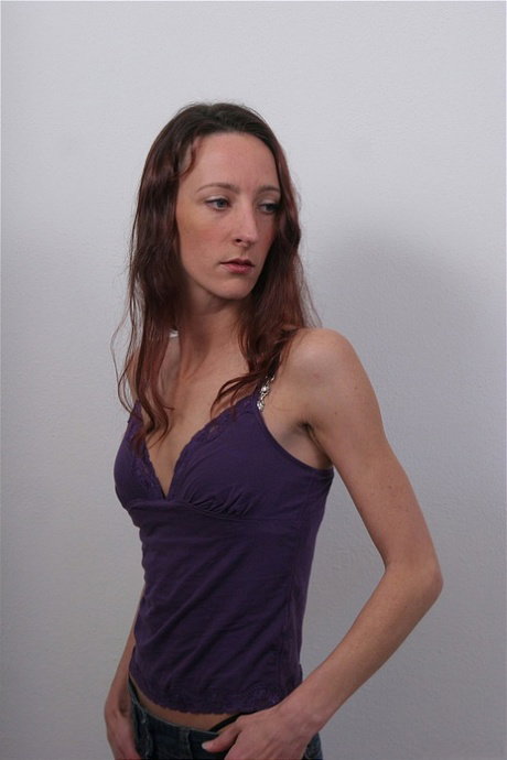 Skinny female slowly removes her clothes to model bare naked