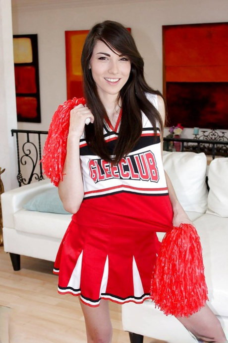 Naughty teen girl Emily Grey posing solo in sexy cheerleader uniform