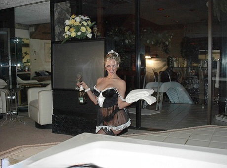Blond maid Naughty Julie masturbates her soap covered twat on the side of tub
