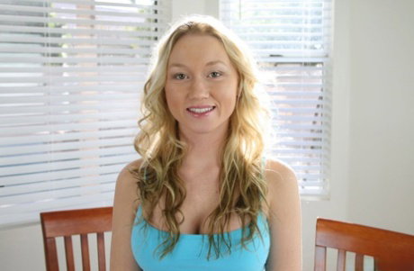 Big boobed blonde peels off her pants before proceeding to masturbate
