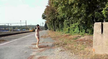 Dark haired girl Lady Dee wanders off the side off a road to take a pee