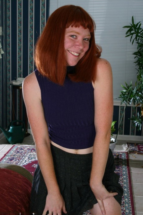 Redheaded amateur sports bushy pits and pubic hairs while getting naked