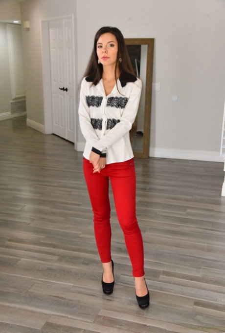 Brunette teen Milana May frees her hot body from red pants and a blouse