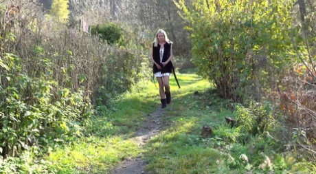 Blonde girl Claudia Macc spreads her pussy lips while taking a pee in nature