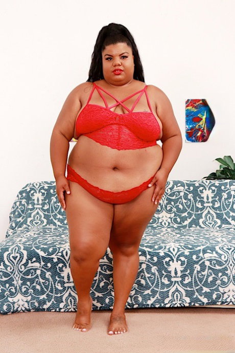 Ebony SSBBW Peaches Love sports red lips while getting completely naked