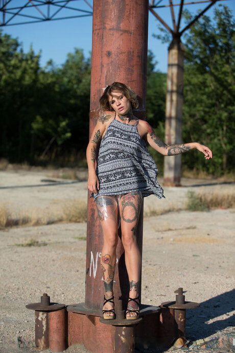 Tattooed girl Stacy Cloud covers her naked body in clear plastic during solo act