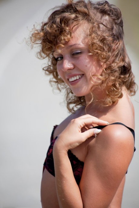 Cute teen undoes her bra and thong combo to go nude on a country road
