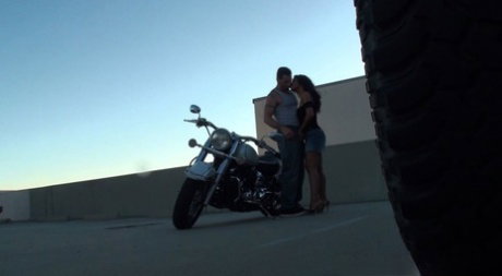 Lovely dark haired chick with big tits sucking and riding dick on the bike