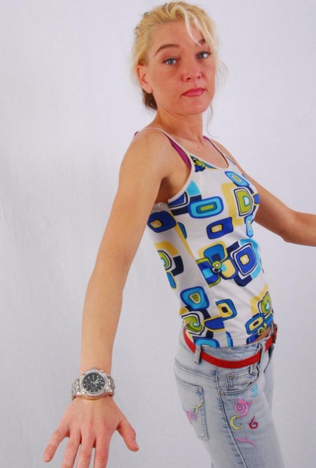 Blue-eyed blonde Lilly models a huge metal watch during safe for work action