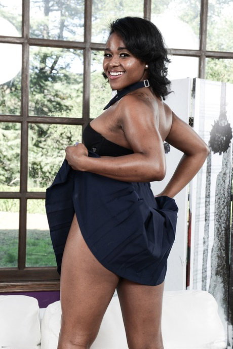 Tiny titted ebony Charlie Rae shows her pierced belly and her bush in a solo