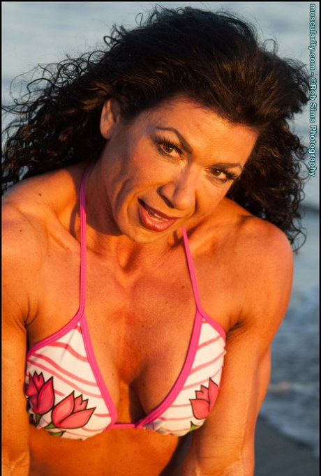 Brunette bodybuilder Andrea Romero poses outdoors for a SFW shoot