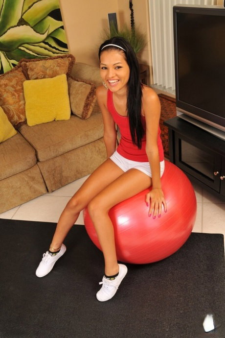 Petite teen Cassie Cruz finger spreads her tight pussy before sucking on her lip