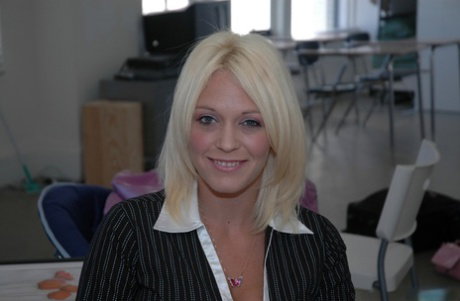 Blonde teacher Charlee Chase undresses at work to free her large breasts