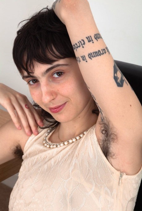 Inked solo girl proudly displays her hairy underarms and vagina