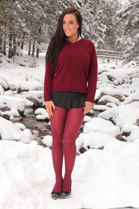 Tanned brunette Stacey P exposes her huge breasts on a snowy day