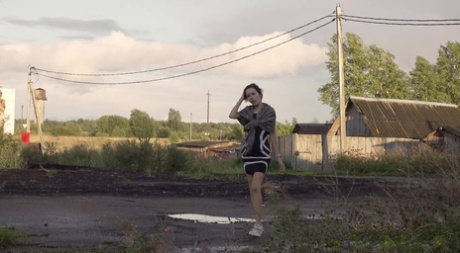 Leggy girl Kristina takes a piss behind a dilapidated building
