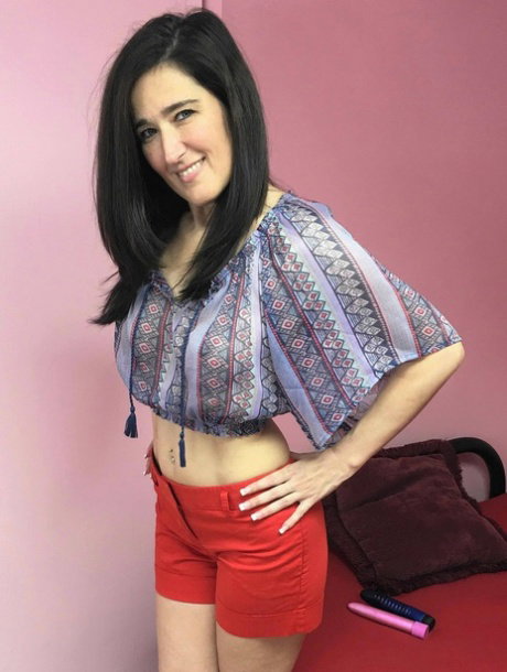 Hot MILF with a big booty Deliah Dukes toys her shaved pussy with her dildos