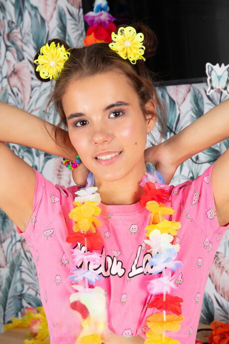 Brunette teen Midia gets naked in over the knee socks and a Hawaiian lei