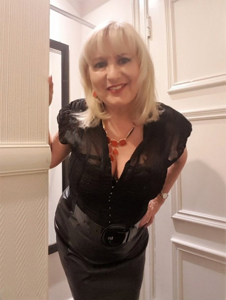 British blonde Lorna Blu displays her moist pussy on a bed in nylons