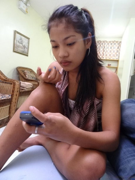 Petite Asian babe Mitch strips naked & shows her trimmed puffy pussy up close