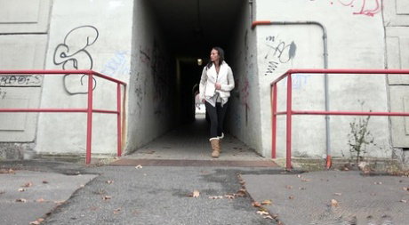 Brunette girl Eveline Neill gets caught pissing at a tunnel entrance in UGGs