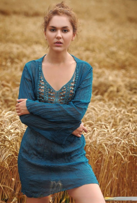 Teen solo girl Jenya A takes off her clothes to pose naked in a field of wheat