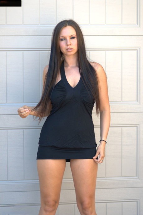 Amateur model Alektra Sky poses in a short dress while wearing her hair down