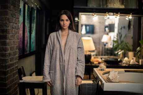 Beautiful brunette Lara Masier gets naked in a robe while in a bathroom