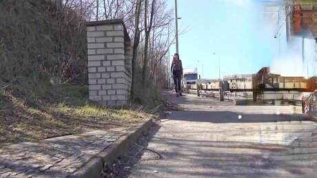 Brunette chick Joana takes a piss on a roadside embankment