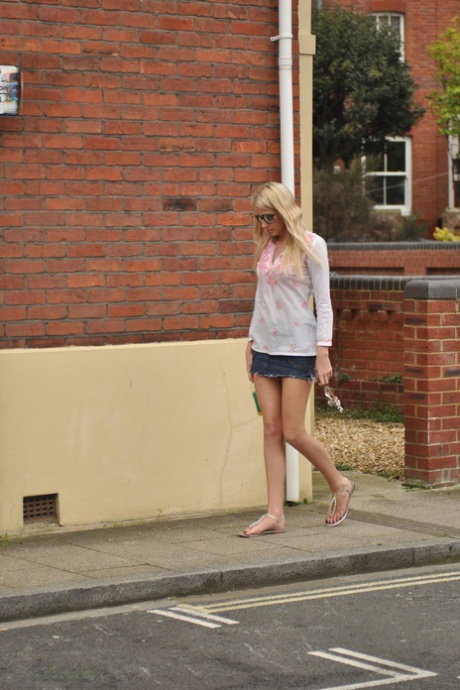 Leggy blonde girl Danielle Maye uncups her firm tits after taking a walk