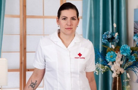Brunette nurse Sharlyn spreads her hairy twat in white nylons and garters