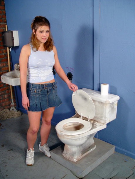 Teen Katie Thomas sucks boner sticking out of the wall in very dirty WC