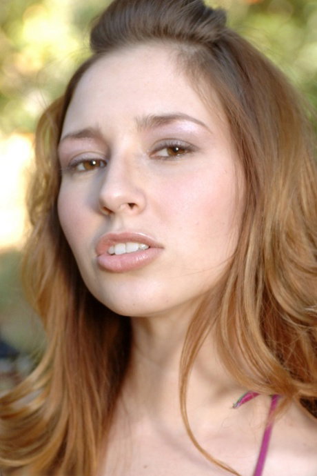 Solo girl Shay Laren removes a bikini upon a blanket in the yard