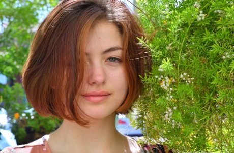Pretty natural redhead Aria-II undressing outdoors to flaunt her nice big tits