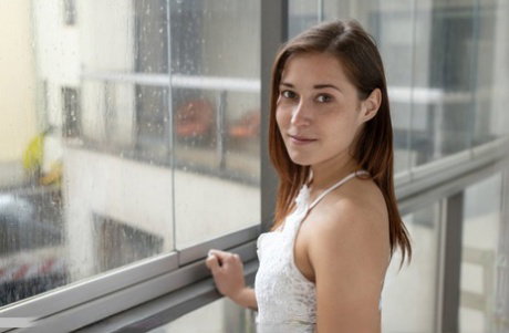 Teen model Mina confidently display her naked body on living room furniture