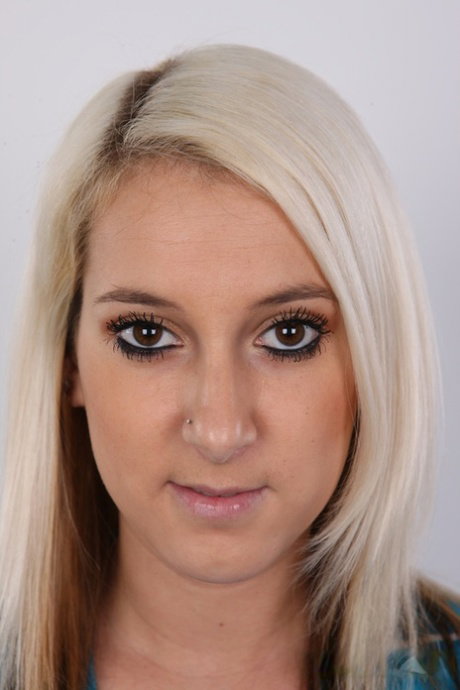 Blonde amateur with a pierced belly button takes a seat after getting naked