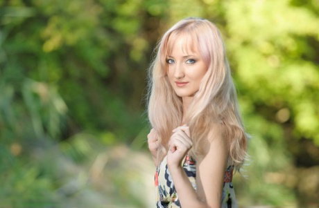 Teen model Zemira A slips off her dress to pose totally nude by a river