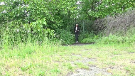 Brunette chick Nicky pulls down her pants to pee near the bushes